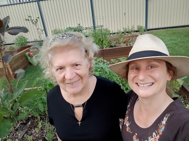 Doreen with a client in a thriving vegetable garden